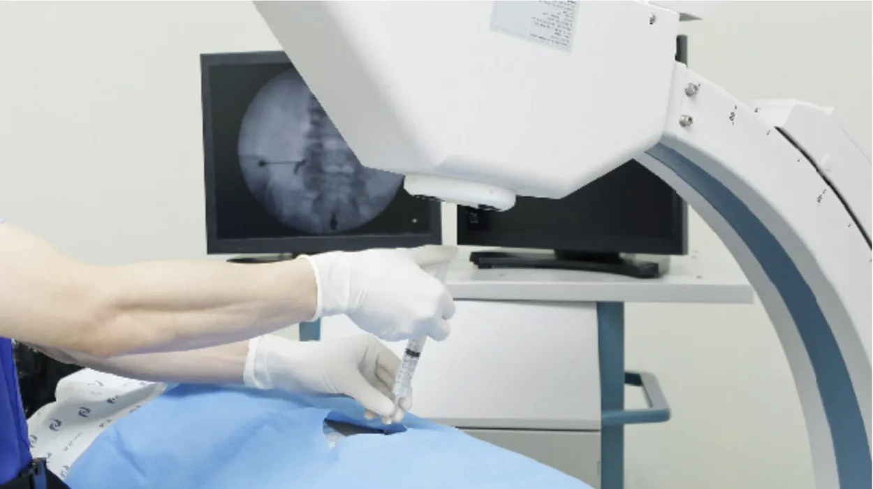 Doctor from Incheon Himchan General Hospital performing a guided spinal injection under fluoroscopy using a C-arm imaging device