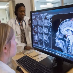 researchers reviewing brain MRI scans and blood test results during a study on stem cell therapy for depression in a modern laboratory